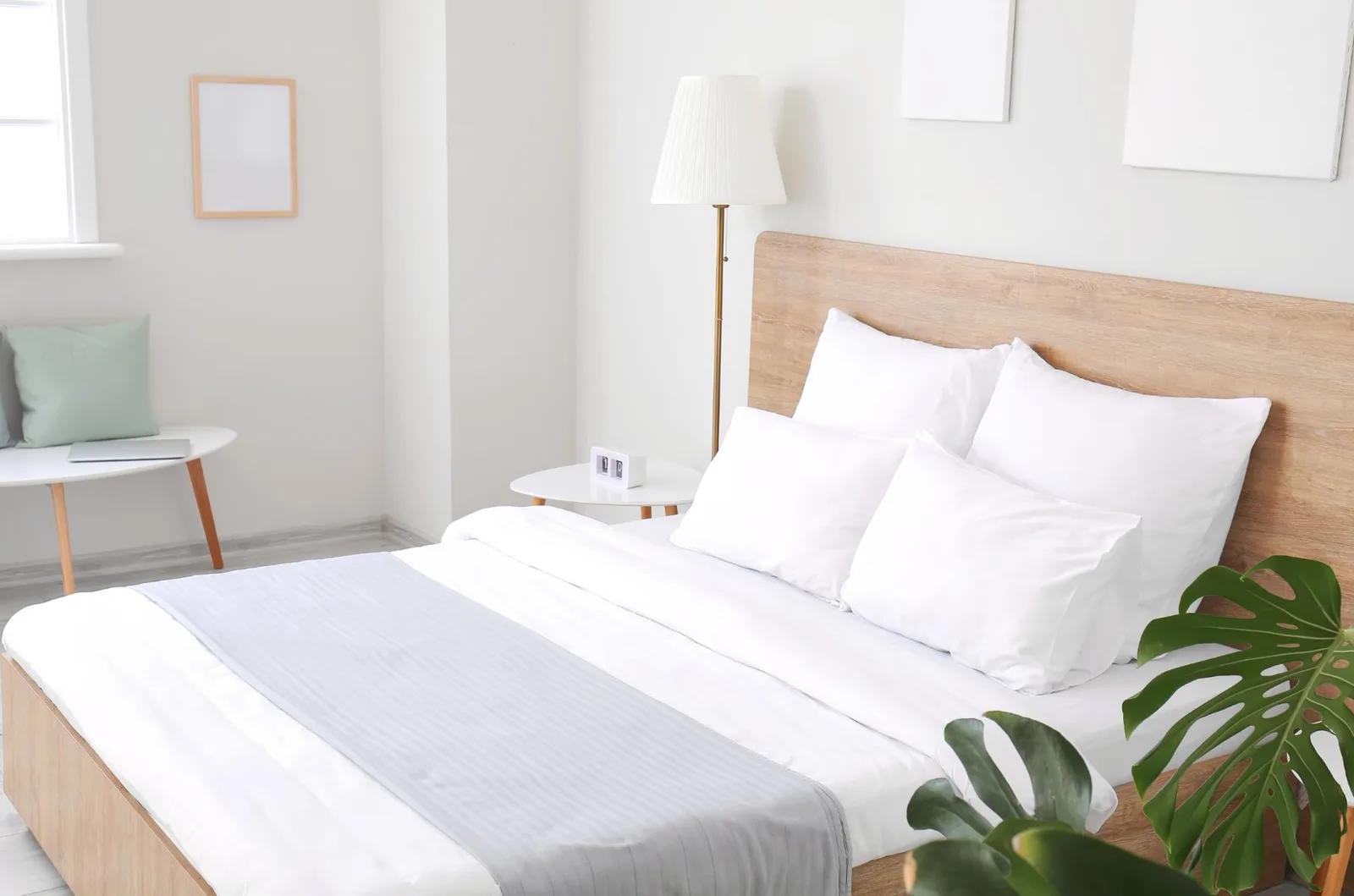 Cama de hotel preparada con sábanas blancas